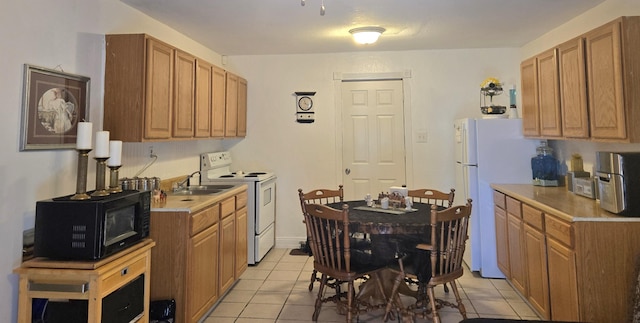 662 Avenida Perea, Bernalillo, NM 87004 - kitchen featuring white appliances, light tile patterned floors, light countertops, and brown cabinets