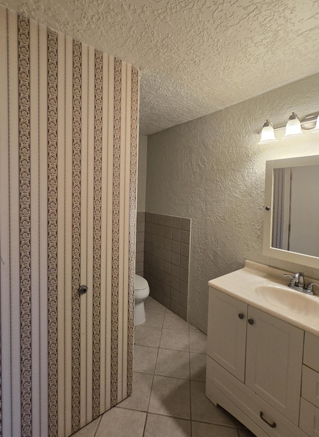 662 Avenida Perea, Bernalillo, NM 87004 - bathroom with a textured ceiling, a textured wall, vanity, tile patterned floors, and tile walls