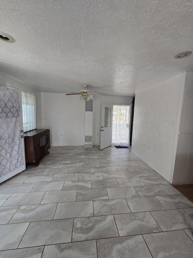 662 Avenida Perea, Bernalillo, NM 87004 - unfurnished room featuring a textured ceiling, a ceiling fan, and a heating unit