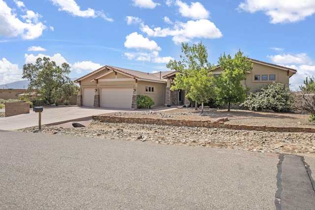 2632 Globe Ct NE, Rio Rancho, NM 87124 - view of front of property featuring stucco siding, stone siding, an attached garage, and driveway