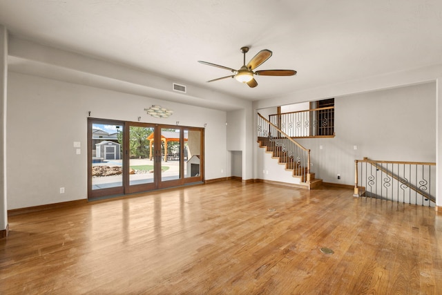 2632 Globe Ct NE, Rio Rancho, NM 87124 - unfurnished living room with wood finished floors, ceiling fan, and french doors