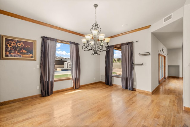 2632 Globe Ct NE, Rio Rancho, NM 87124 - spare room with a chandelier, light wood-style floors, and crown molding