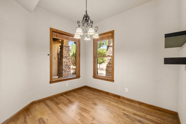 2632 Globe Ct NE, Rio Rancho, NM 87124 - unfurnished room with a chandelier and light wood-type flooring