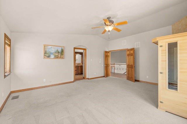 2632 Globe Ct NE, Rio Rancho, NM 87124 - unfurnished room featuring a ceiling fan, light colored carpet, lofted ceiling, and arched walkways
