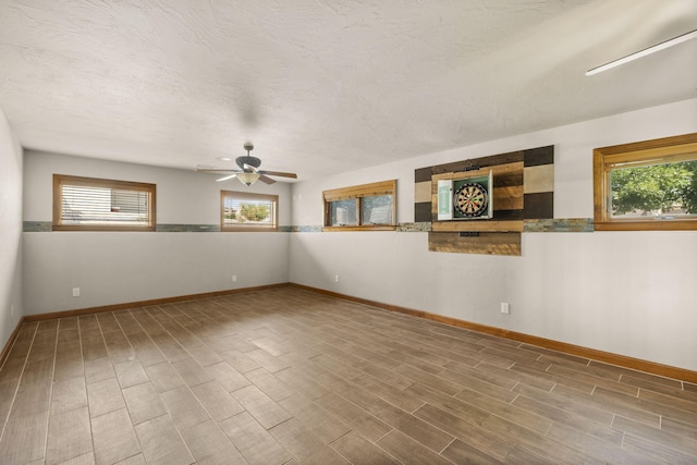 2632 Globe Ct NE, Rio Rancho, NM 87124 - unfurnished room featuring plenty of natural light, wood finished floors, and a ceiling fan