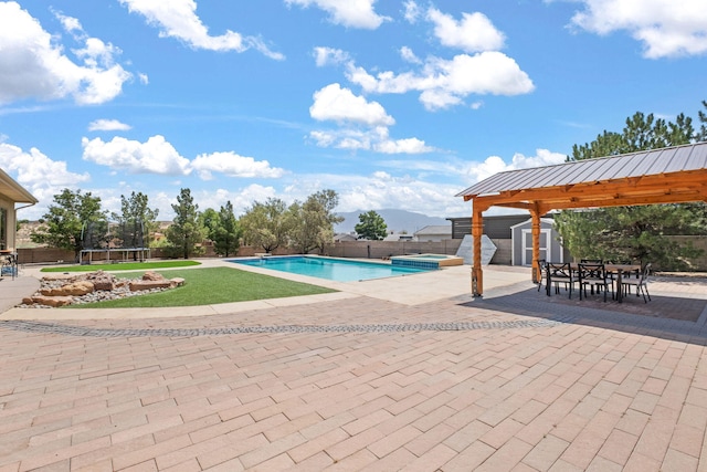 2632 Globe Ct NE, Rio Rancho, NM 87124 - view of swimming pool featuring a trampoline, a storage shed, a patio, and outdoor dining area