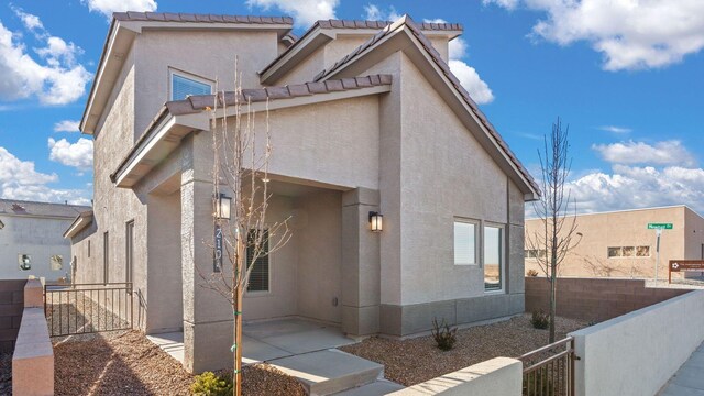 5623 Sagan Loop SE, Albuquerque, NM 87106 - view of front facade with stucco siding, a patio area, and a tile roof
