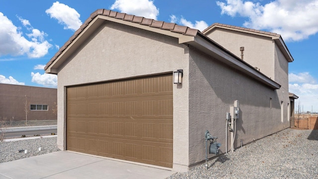5623 Sagan Loop SE, Albuquerque, NM 87106 - view of side of home featuring stucco siding and a garage