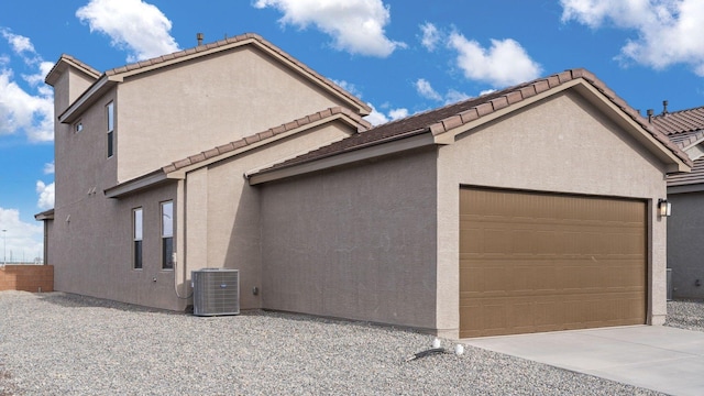 5623 Sagan Loop SE, Albuquerque, NM 87106 - view of side of property featuring an attached garage, stucco siding, and a tile roof