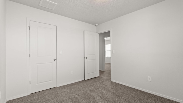5623 Sagan Loop SE, Albuquerque, NM 87106 - unfurnished bedroom featuring carpet floors and a textured ceiling