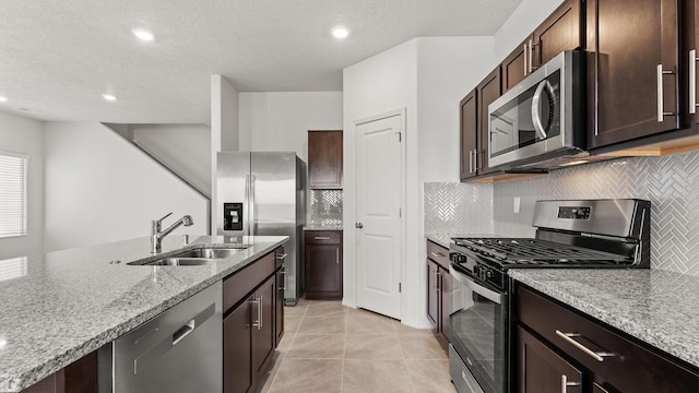 5623 Sagan Loop SE, Albuquerque, NM 87106 - kitchen with stainless steel appliances, tasteful backsplash, light stone countertops, dark brown cabinets, and recessed lighting