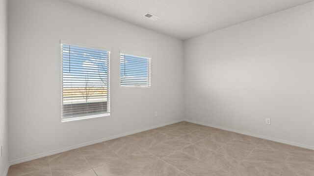 5623 Sagan Loop SE, Albuquerque, NM 87106 - empty room with baseboards and a textured ceiling