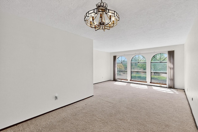 5207 Russell Dr NW, Albuquerque, NM 87114 - carpeted empty room with a chandelier and a textured ceiling