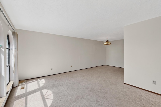 5207 Russell Dr NW, Albuquerque, NM 87114 - carpeted spare room with a chandelier and baseboards