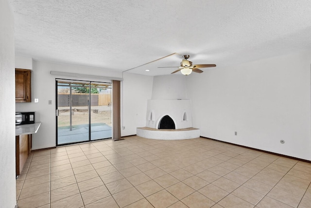 5207 Russell Dr NW, Albuquerque, NM 87114 - unfurnished living room with a textured ceiling, ceiling fan, a fireplace, and light tile patterned floors