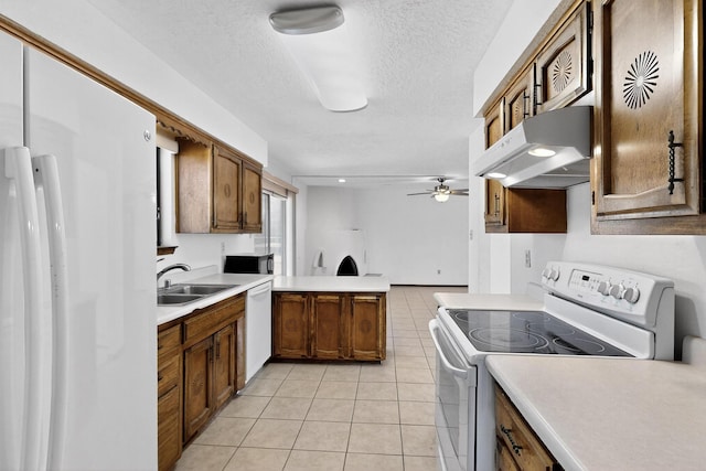 5207 Russell Dr NW, Albuquerque, NM 87114 - kitchen with white appliances, exhaust hood, a peninsula, light tile patterned floors, and brown cabinets