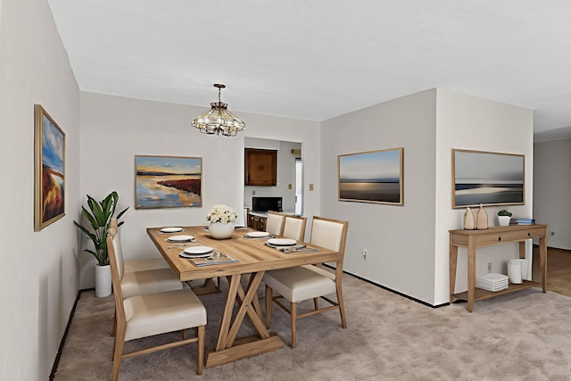 5207 Russell Dr NW, Albuquerque, NM 87114 - dining room featuring a chandelier and light carpet