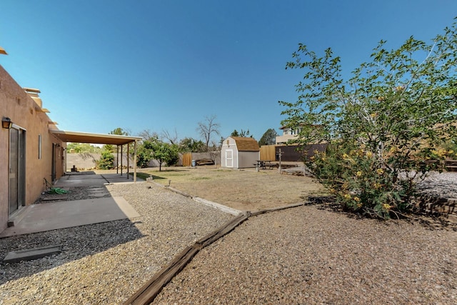 5207 Russell Dr NW, Albuquerque, NM 87114 - fenced backyard featuring a storage unit and a patio