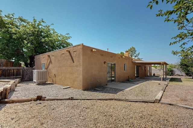 5207 Russell Dr NW, Albuquerque, NM 87114 - back of property with a patio area, stucco siding, and a chimney