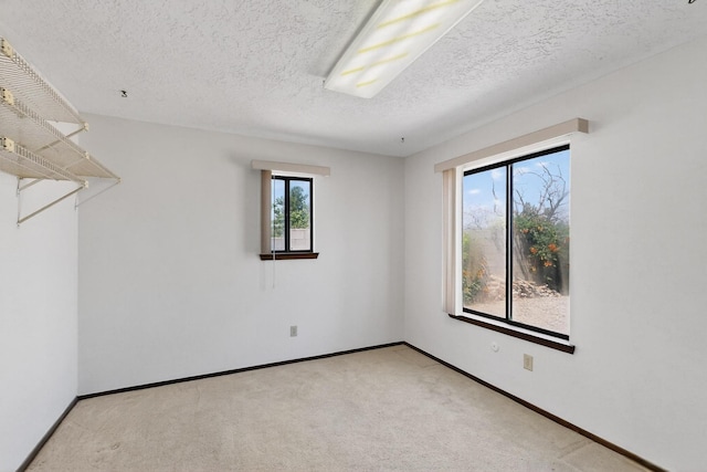 5207 Russell Dr NW, Albuquerque, NM 87114 - empty room with healthy amount of natural light, light carpet, and a textured ceiling