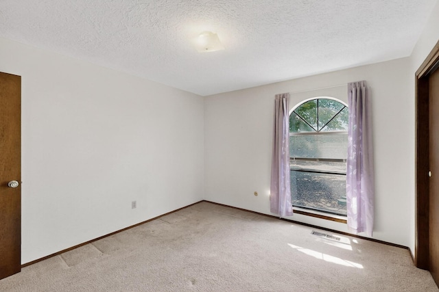 5207 Russell Dr NW, Albuquerque, NM 87114 - unfurnished room featuring carpet floors and a textured ceiling