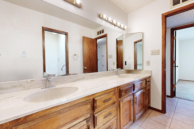 5207 Russell Dr NW, Albuquerque, NM 87114 - bathroom featuring double vanity and tile patterned floors