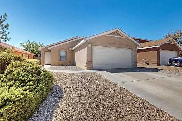 7408 Estes Park Ave NW, Albuquerque, NM 87114 - ranch-style house with stucco siding, an attached garage, and driveway