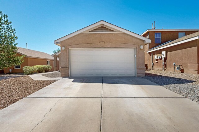 7408 Estes Park Ave NW, Albuquerque, NM 87114 - view of front facade featuring concrete driveway and stucco siding