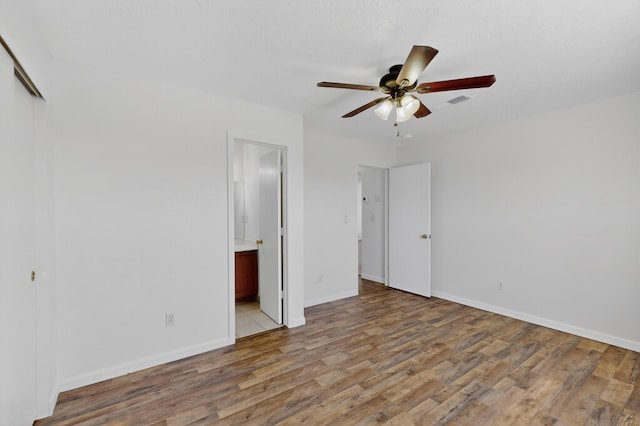 7408 Estes Park Ave NW, Albuquerque, NM 87114 - unfurnished bedroom featuring light wood finished floors, ensuite bathroom, a closet, and a ceiling fan