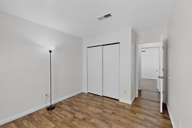 7408 Estes Park Ave NW, Albuquerque, NM 87114 - unfurnished bedroom with wood finished floors and a closet