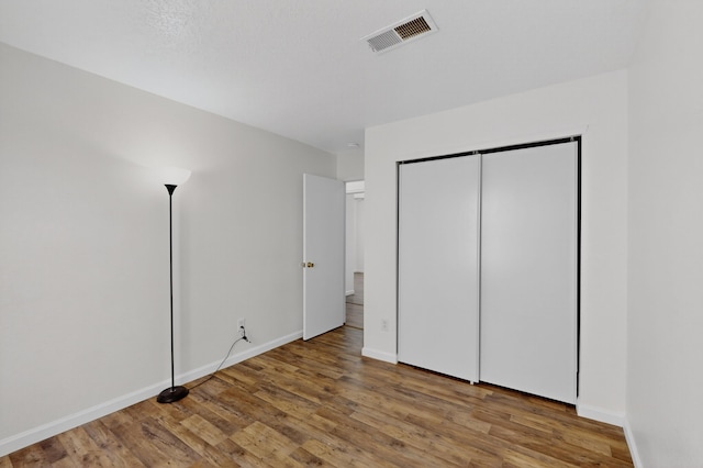 7408 Estes Park Ave NW, Albuquerque, NM 87114 - unfurnished bedroom with wood finished floors and a closet