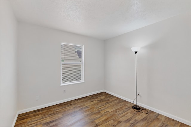 7408 Estes Park Ave NW, Albuquerque, NM 87114 - unfurnished room with wood finished floors and a textured ceiling