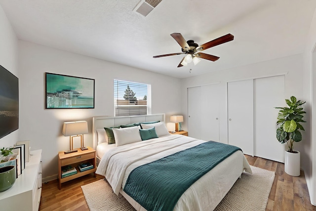 7408 Estes Park Ave NW, Albuquerque, NM 87114 - bedroom featuring two closets, light wood-style floors, and ceiling fan