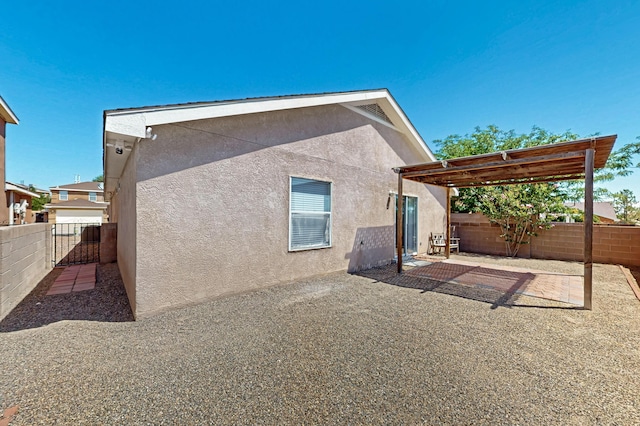 7408 Estes Park Ave NW, Albuquerque, NM 87114 - back of house featuring stucco siding, a fenced backyard, a patio, and a pergola