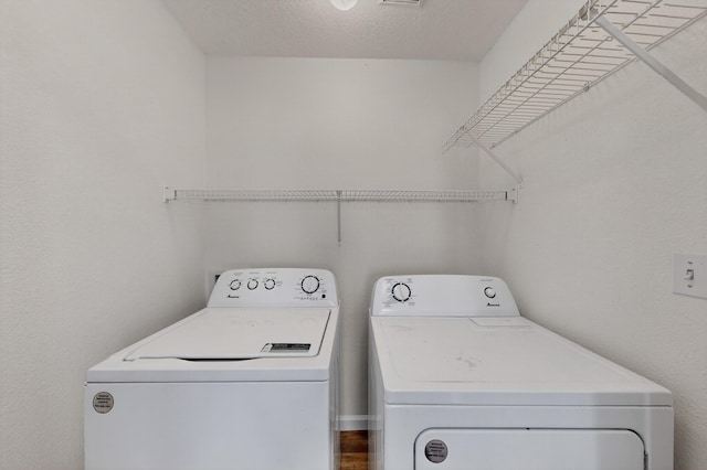 7408 Estes Park Ave NW, Albuquerque, NM 87114 - laundry area with washing machine and clothes dryer and a textured ceiling