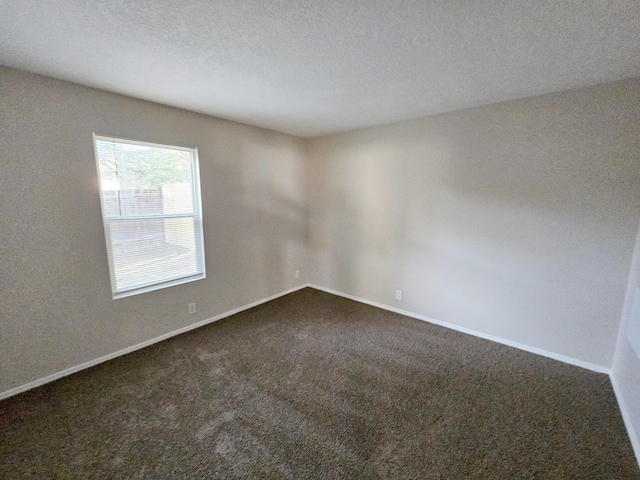 7235 Whippoorwill Ln NE, Albuquerque, NM 87109 - empty room with dark colored carpet and a textured ceiling