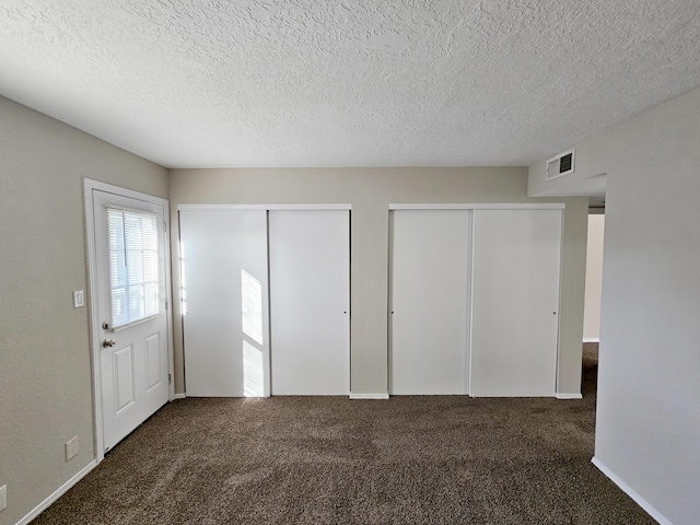 7235 Whippoorwill Ln NE, Albuquerque, NM 87109 - unfurnished bedroom with multiple closets, carpet flooring, and a textured ceiling