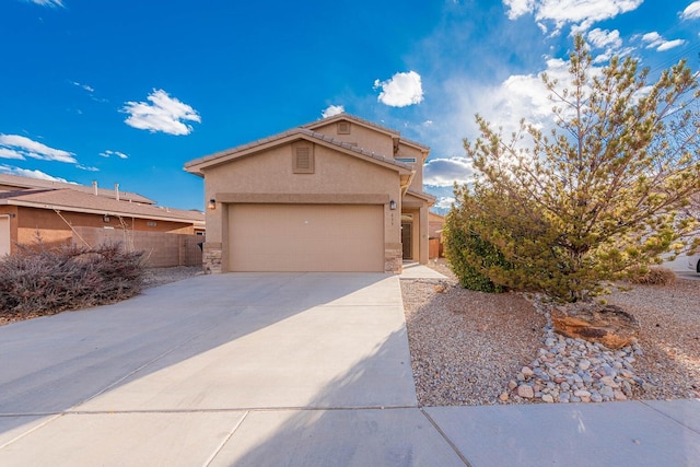 839 Serrano Pointe NW, Albuquerque, NM 87120 - view of front of house with stucco siding, concrete driveway, a garage, and stone siding