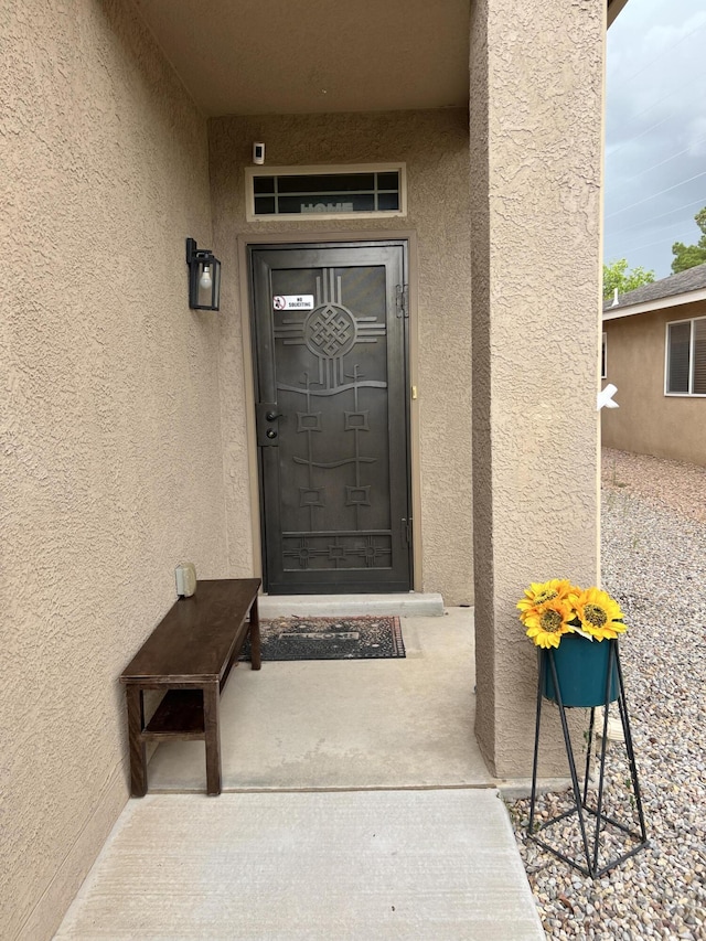 839 Serrano Pointe NW, Albuquerque, NM 87120 - doorway to property with stucco siding