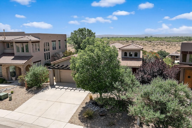1128 San Augustin Dr, Bernalillo, NM 87004 - view of front of home with a garage, driveway, a tile roof, and stucco siding