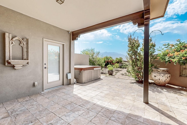 1128 San Augustin Dr, Bernalillo, NM 87004 - view of patio / terrace with a hot tub and a mountain view
