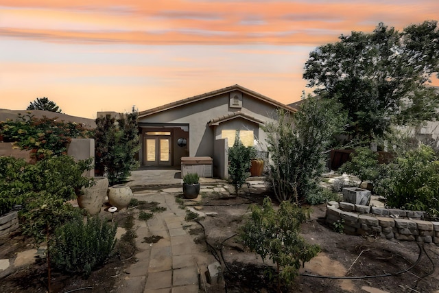 1128 San Augustin Dr, Bernalillo, NM 87004 - view of front of house featuring french doors, stucco siding, and a patio area