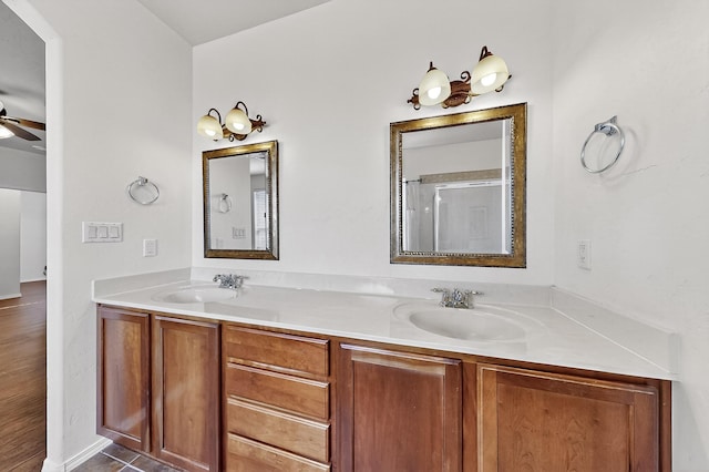 1128 San Augustin Dr, Bernalillo, NM 87004 - bathroom with double vanity, a shower with door, and a ceiling fan
