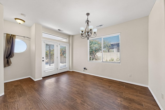 1128 San Augustin Dr, Bernalillo, NM 87004 - unfurnished dining area featuring healthy amount of natural light, a chandelier, and wood finished floors