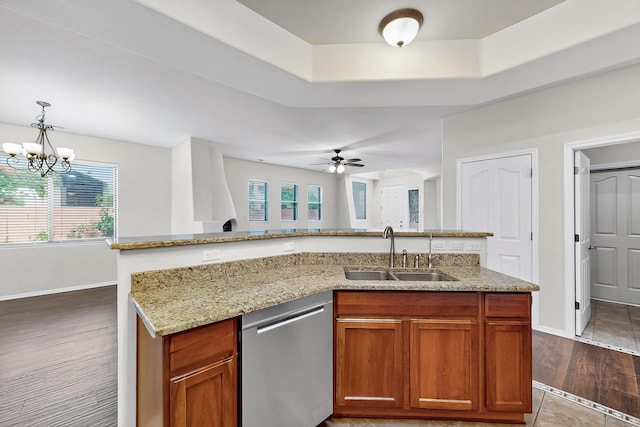 1128 San Augustin Dr, Bernalillo, NM 87004 - kitchen with dishwasher, light stone counters, a ceiling fan, a raised ceiling, and decorative light fixtures