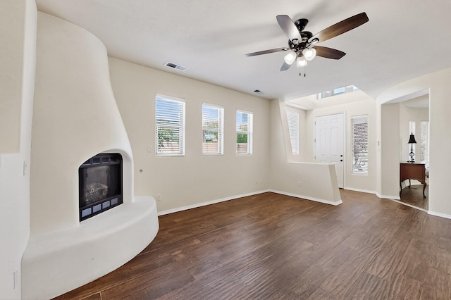 1128 San Augustin Dr, Bernalillo, NM 87004 - unfurnished living room featuring wood finished floors, a ceiling fan, and a fireplace