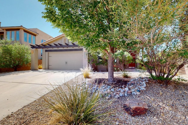 1128 San Augustin Dr, Bernalillo, NM 87004 - view of front of home featuring an attached garage, concrete driveway, and stucco siding