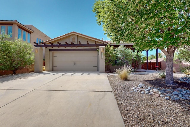 1128 San Augustin Dr, Bernalillo, NM 87004 - view of front facade with stucco siding, concrete driveway, an attached garage, and a tiled roof