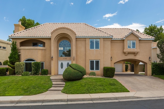 11201 Country Clb NE, Albuquerque, NM 87111 - mediterranean / spanish house featuring concrete driveway, a front lawn, and stucco siding