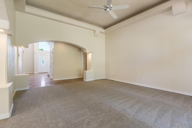 11201 Country Clb NE, Albuquerque, NM 87111 - unfurnished room with arched walkways, carpet floors, ceiling fan, and a raised ceiling